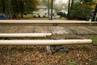 In this Tuesday, Oct. 22, 2019 photo, pipes lay along a construction site on the Mariner East pipeline in a residential neighborhood in Exton, Pa. The 350-mile (560-kilometer) pipeline route traverses those suburbs, close to schools, ballfields and senior care facilities. The spread of drilling, compressor stations and pipelines has changed neighborhoods — and opinions. (AP Photo/Matt Rourke)