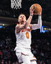 New York Knicks guard Donte DiVincenzo shoots at the rim during the first half of an NBA basketball game against the Detroit Pistons in New York, Monday, March 25, 2024. (AP Photo/Peter K. Afriyie)
