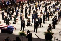 <p>Attendees stood and clapped for Peoples during the ceremony. According to <em><a href="https://abcnews.go.com/US/boy-troy-funeral-services-begin-late-rep-john/story?id=71985321" rel="nofollow noopener" target="_blank" data-ylk="slk:ABC News;elm:context_link;itc:0;sec:content-canvas" class="link ">ABC News</a></em>, the funeral was conducted in "homegoing" style, "a word used to describe African American funerals celebrating the life of the deceased which often includes heartfelt remembrances."<br></p>