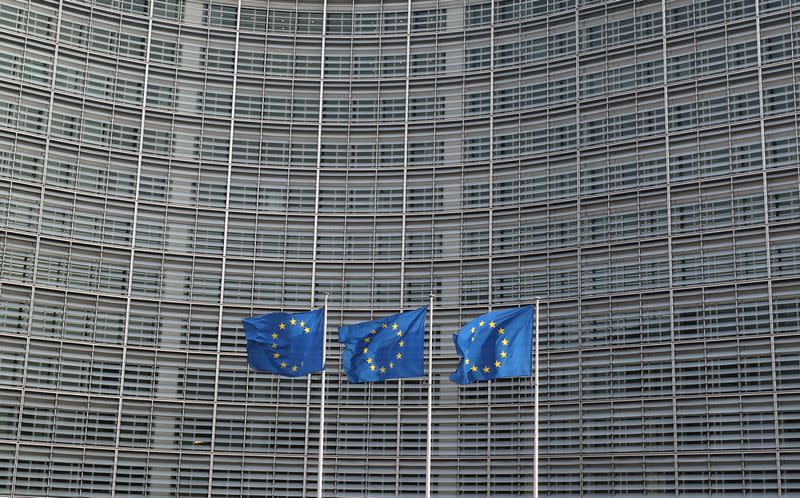 FILE PHOTO: European Union flags fly outside the European Commission headquarters in Brussels