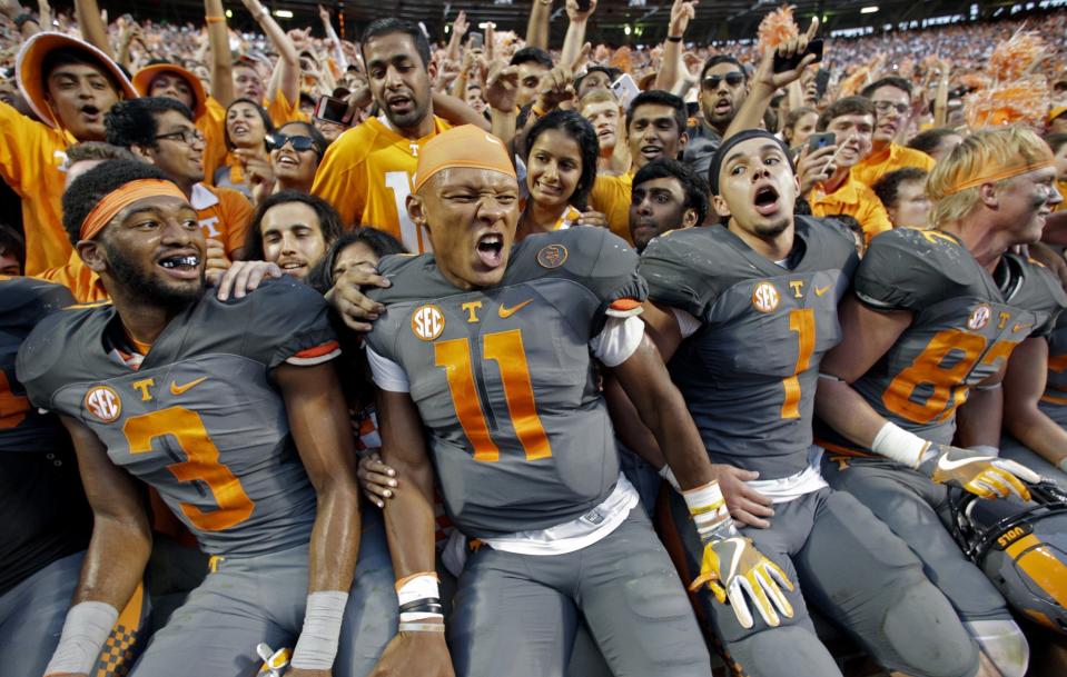 Tennessee QB Joshua Dobbs (11) has had reason to celebrate this season but is a polarizing NFL prospect. (AP)