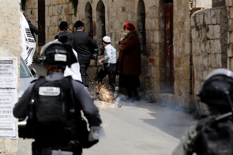 A stun grenade explodes during scuffles with ultra-Orthodox Jews as police patrol streets to enforce a partial lockdown against the coronavirus disease (COVID-19) in Mea Shearim neighbourhood of Jerusalem