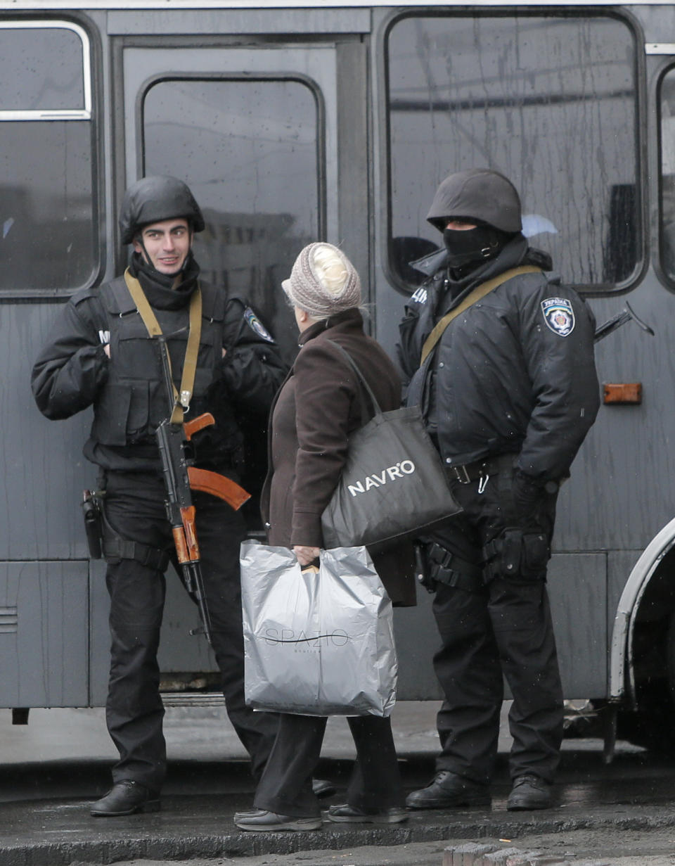 A woman speaks to riot police officers at the Hotel Dnipro in Kiev, Ukraine, Tuesday, April 1, 2014. A tense standoff between Ukrainian police and a radical nationalist group Right Sector ended Tuesday, when its members surrendered their weapons and left a downtown hotel. Their departure followed a shooting spree in the capital, in which a Right Sector member shot and wounded three people outside a restaurant adjacent to the capital’s main Independence Square, including a deputy mayor of the capital. (AP Photo/Efrem Lukatsky)