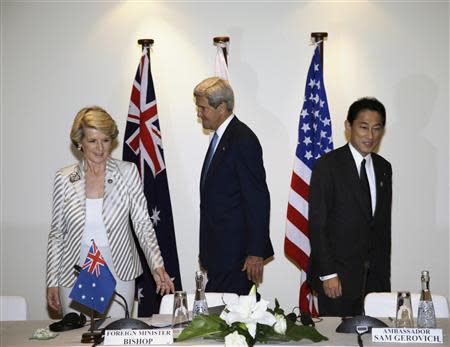 Australia's Foreign Minister Julie Bishop (L-R), U.S. Secretary of State John Kerry and Japanese Foreign Minister Fumio Kishida prepare to take seats for their trilateral meeting ahead of the Asia Pacific Economic Cooperation (APEC) forum in Bali, October 4, 2013. REUTERS/Dita Alangkara/Pool