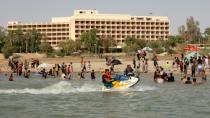 Iraqis swim and ride jet-skis on Lake Habbaniyah on June 17, 2012, during a brief revival of the resort before the Islamic State group moved into the area