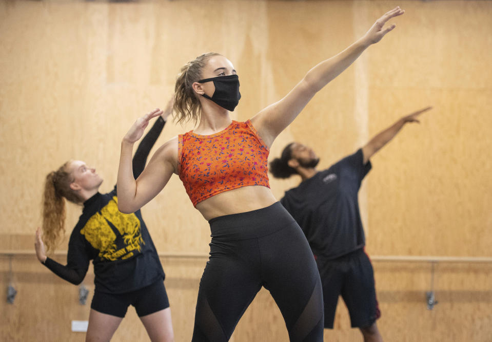 Students observe social distancing as they take part in a dance session as classes resume at Mountview Academy of Theatre Arts drama school following its closure due to coronavirus, in Peckham, south London, Tuesday, Sept. 8, 2020. (Dominic Lipinski/PA via AP)