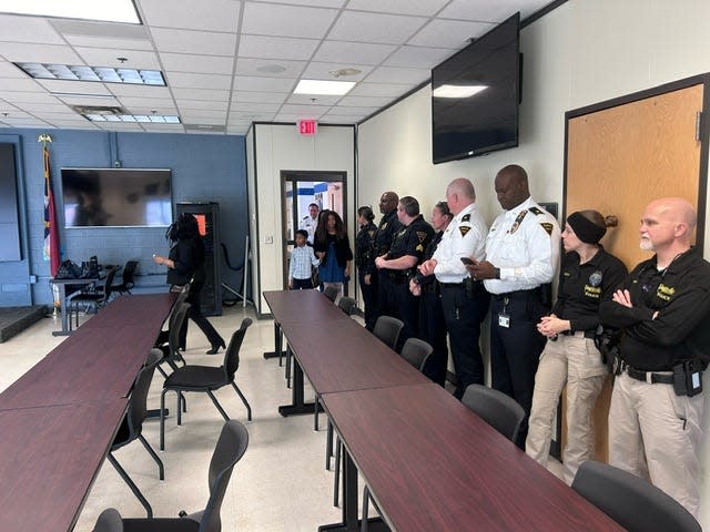 Fayetteville police officers line up at the police department for a hug on Friday, Jan. 26, 2024.