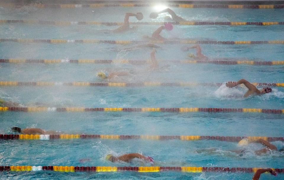 ASU swim team members cut through the rising steam on Dec. 14, 2022, during practice at ASU's Mona Plummer Aquatic Center in Tempe. The temperature during the 6-8 a.m. practice was 37 degrees, and the water temperature was 80 degrees.