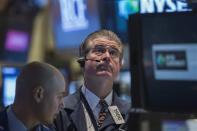 Trader Daniel Kryger (R) looks up at a screen while working on the floor of the New York Stock Exchange February 27, 2014. REUTERS/Brendan McDermid