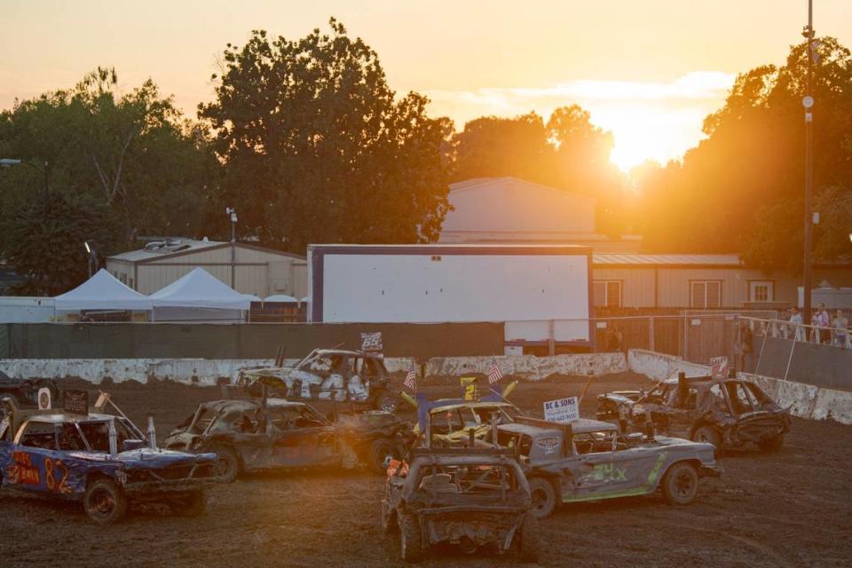 The sun sets during the demolition derby at Rodeo Arena inside the California State Fair on Saturday, July 22, 2023, in Sacramento.


