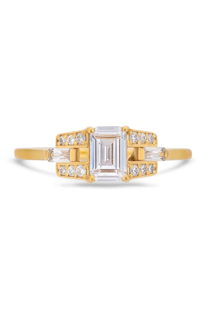 <p><em><strong>V by Laura Vann</strong> White Emerald Cut Diamond, White Baguette Side Stones and White Brilliant Cut Diamonds</em><em> in 18K yellow gold</em><em>, $7,080,</em><em> <a href="http://vbylauravann.com/" rel="nofollow noopener" target="_blank" data-ylk="slk:vbylauravann.com.;elm:context_link;itc:0;sec:content-canvas" class="link ">vbylauravann.com.</a></em></p><p><a class="link " href="https://vbylauravann.com/collections/yellow-gold-engagement-rings/products/emerald-cut-diamond-buckle-ring-in-yellow-gold?variant=31199559286818" rel="nofollow noopener" target="_blank" data-ylk="slk:SHOP;elm:context_link;itc:0;sec:content-canvas">SHOP</a></p>