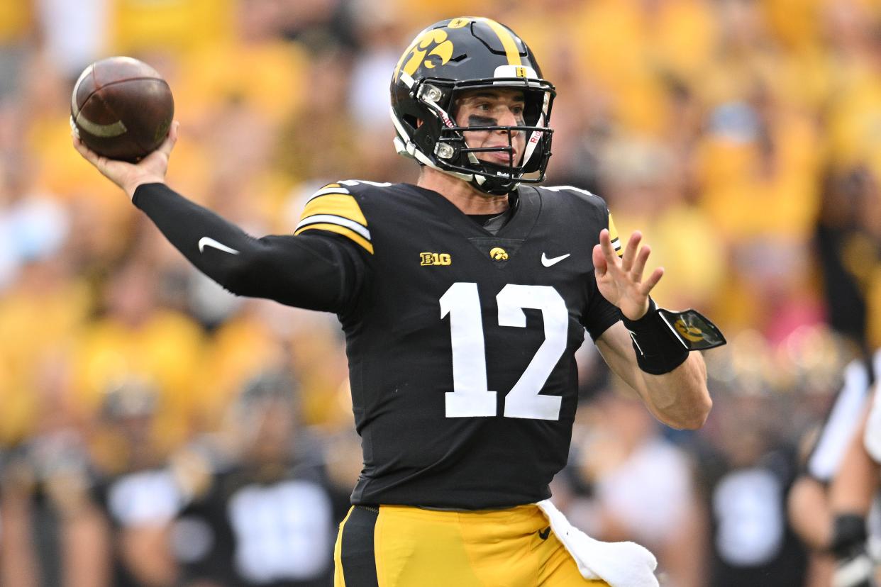 Sep 16, 2023; Iowa City, Iowa, USA; Iowa Hawkeyes quarterback Cade McNamara (12) throws a pass against the Western Michigan Broncos during the fourth quarter at Kinnick Stadium. Mandatory Credit: Jeffrey Becker-USA TODAY Sports