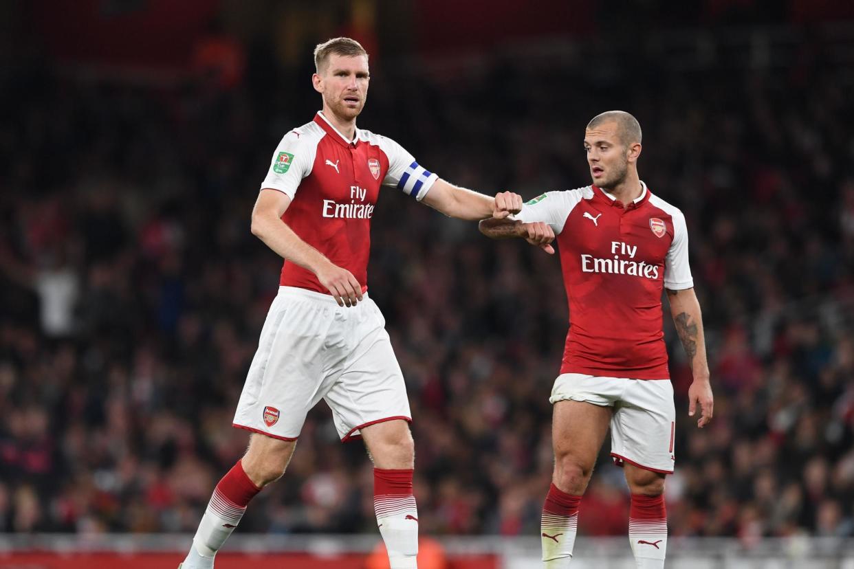 Mertesacker and Wilshere have been working on their coaching qualifications: Arsenal FC via Getty Images