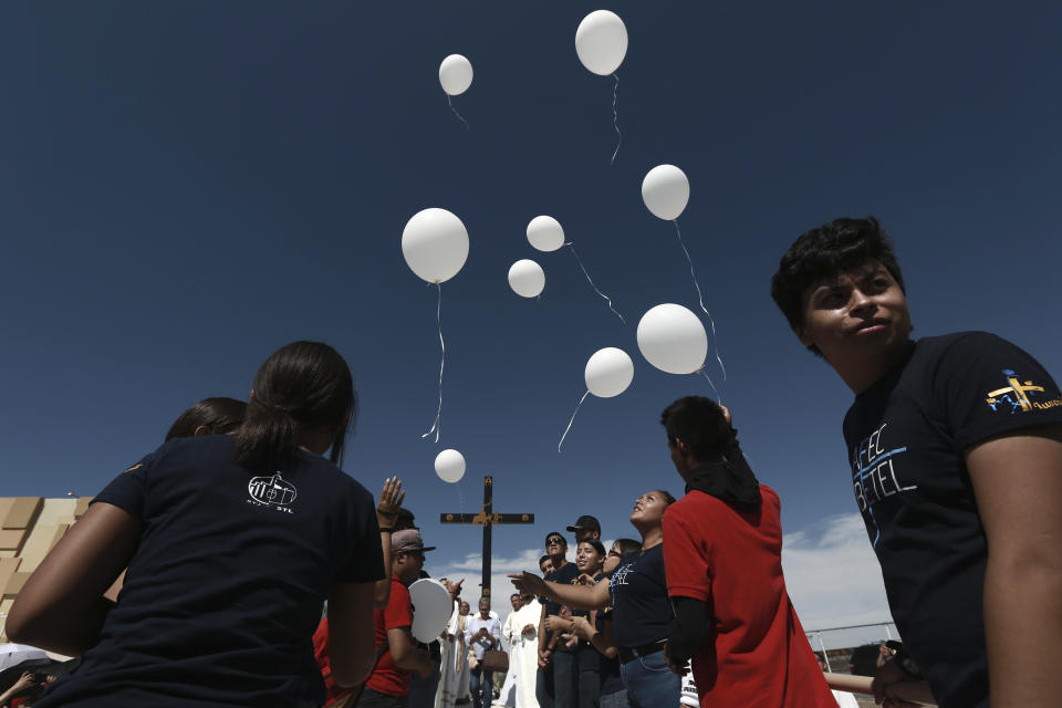 Faithful release balloons during a Mass for peace, in Ciudad Juarez, Mexico, Saturday, Aug. 10, 2019, marking the one week anniversary of a shooting that killed 22 at a Walmart in El Paso. Authorities say the man accused of carrying out last weekend's deadly mass shooting confessed to officers that he had been targeting Mexicans. (AP Photo/Christian Chavez)