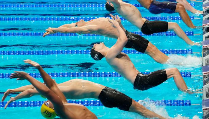 Ryan Murphy (Cal cap, in center) launches from the wall in the men's 100 backstroke semifinal at the U.S. Olympic Trials.