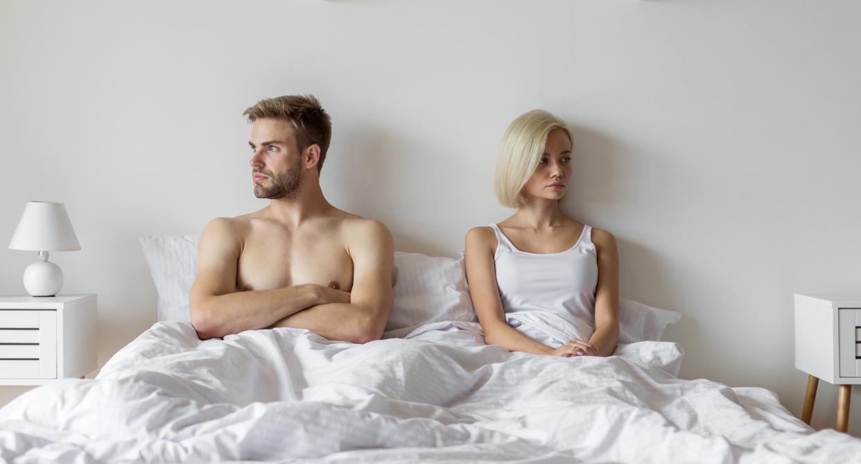 Angry couple in bed looking opposite ways as study finds watching porn can cause 'dissatisfaction' and 'instability' in relationships. (Getty Images)