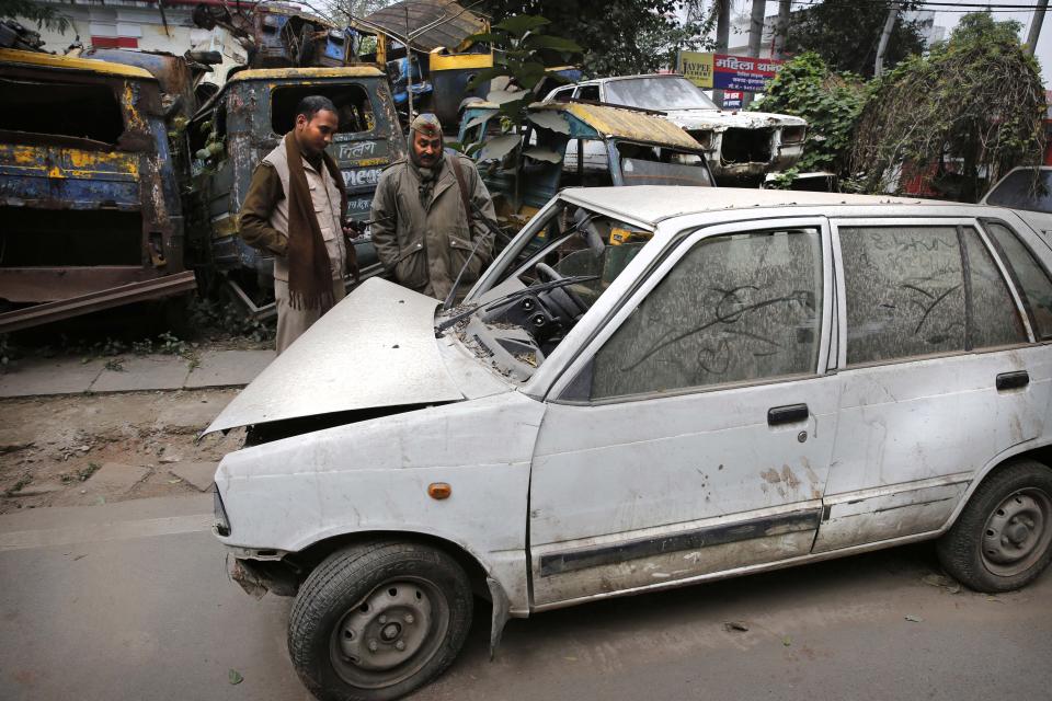 Policemen look at an accident small car in Allahabad, India, Friday, Jan. 31, 2014. Several of India's most popular car models crumpled in independent crash tests in ways that would likely lead to fatality or serious injury, a global car safety watchdog said Friday. The results are an indictment of the auto industry in India, which lacks adequate safety standards, said David Ward, head of the London car-safety watchdog Global NCAP, which performed the crash tests. India has some of the deadliest roads in the world. (AP Photo/Rajesh Kumar Singh)