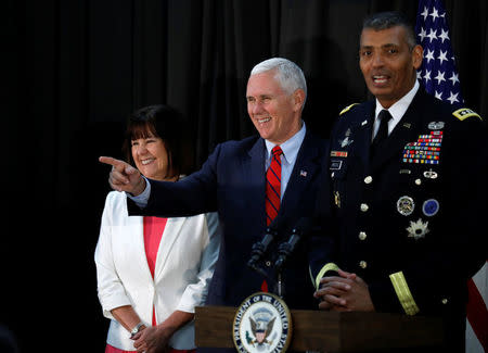 U.S. Vice President Mike Pence reacts as commander General Vincent K. Brooks speaks during an Easter fellowship dinner at a military base in Seoul, South Korea, April 16, 2017. REUTERS/Kim Hong-Ji