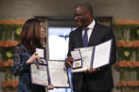 The Peace Prize laureates Dr. Denis Mukwege from Congo and Nadia Murad from Iraq, left, pose together with their medals during the Nobel Peace Prize Ceremony in Oslo Town Hall, Oslo, Monday Dec. 10, 2018. Dr. Denis Mukwege and Nadia Murad receive the Nobel Peace Prize recognising their efforts to end the use of sexual violence as a weapon of war and armed conflict. (Haakon Mosvold Larsen/NTB Scanpix via AP, Pool)