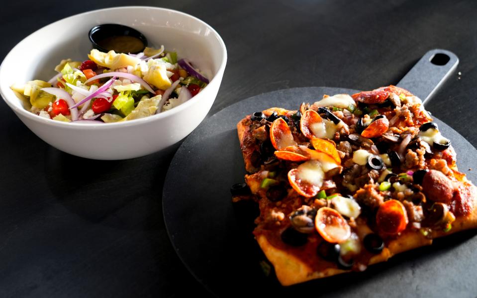 The salad, left, and deluxe pizza will be available from Zaria Italian Street Eats at The Galley on the Levee in Newport.