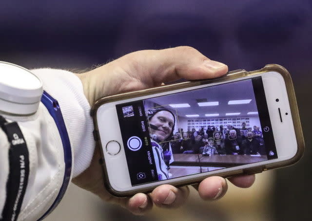 astronaut taking selfie on iPhone 