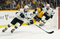 San Jose Sharks defenseman Mario Ferraro (38) brings the puck around the net in the second period of an NHL hockey game against the Nashville Predators Tuesday, Oct. 26, 2021, in Nashville, Tenn. (AP Photo/Mark Humphrey)