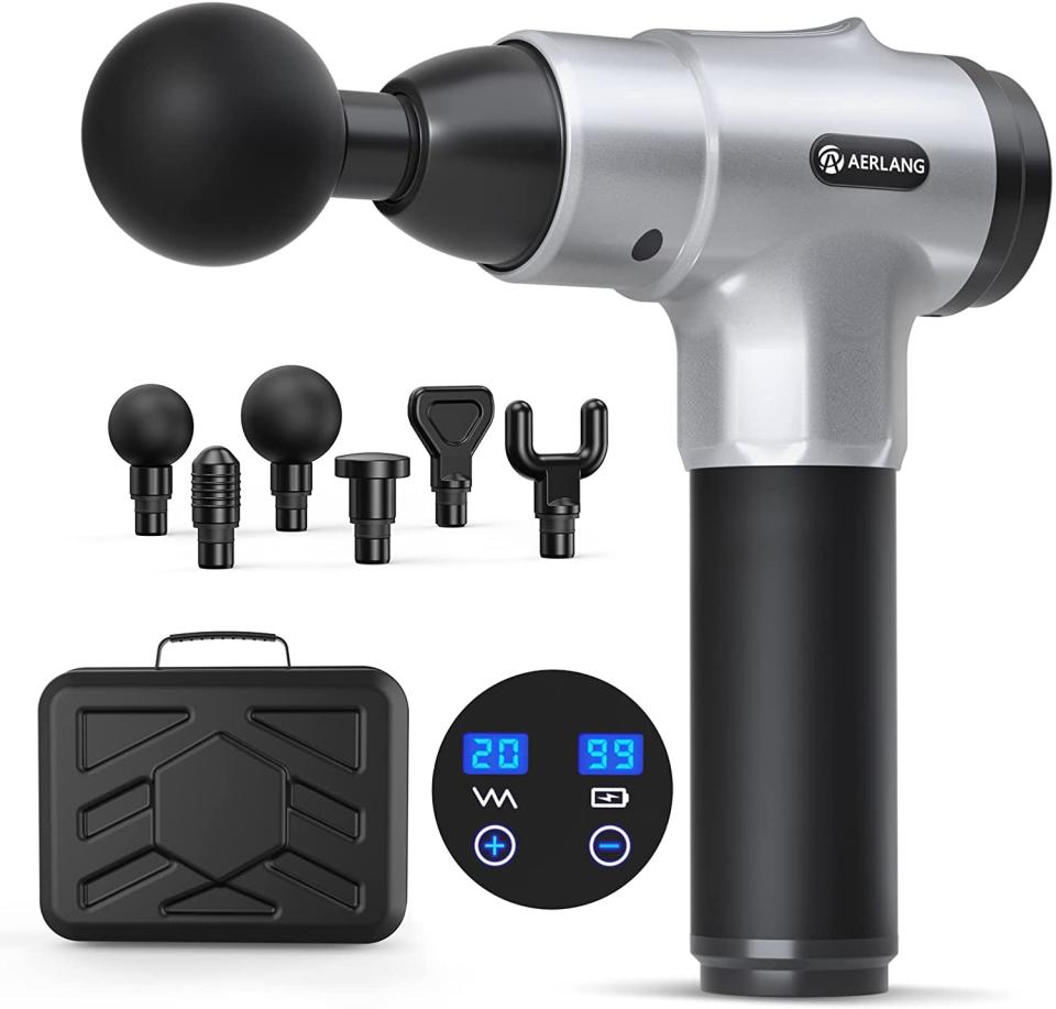 Silver touchscreen massager with six heads and a carrying case