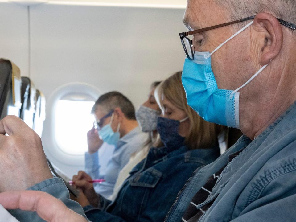 Man wearing mask on plane