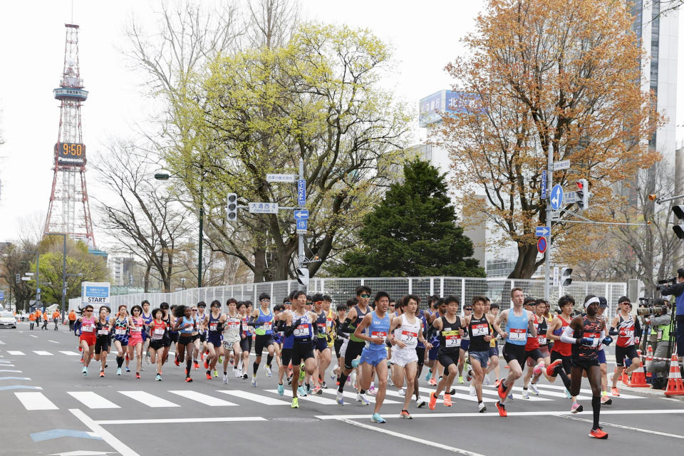 Runners start at the Sapporo challenge half-marathon held as a Tokyo 2020 Olympics test event in Sapporo, northern Japan, Wednesday, May 5, 2021. Sapporo TV Tower is seen at left in the background. (Kyodo News via AP)