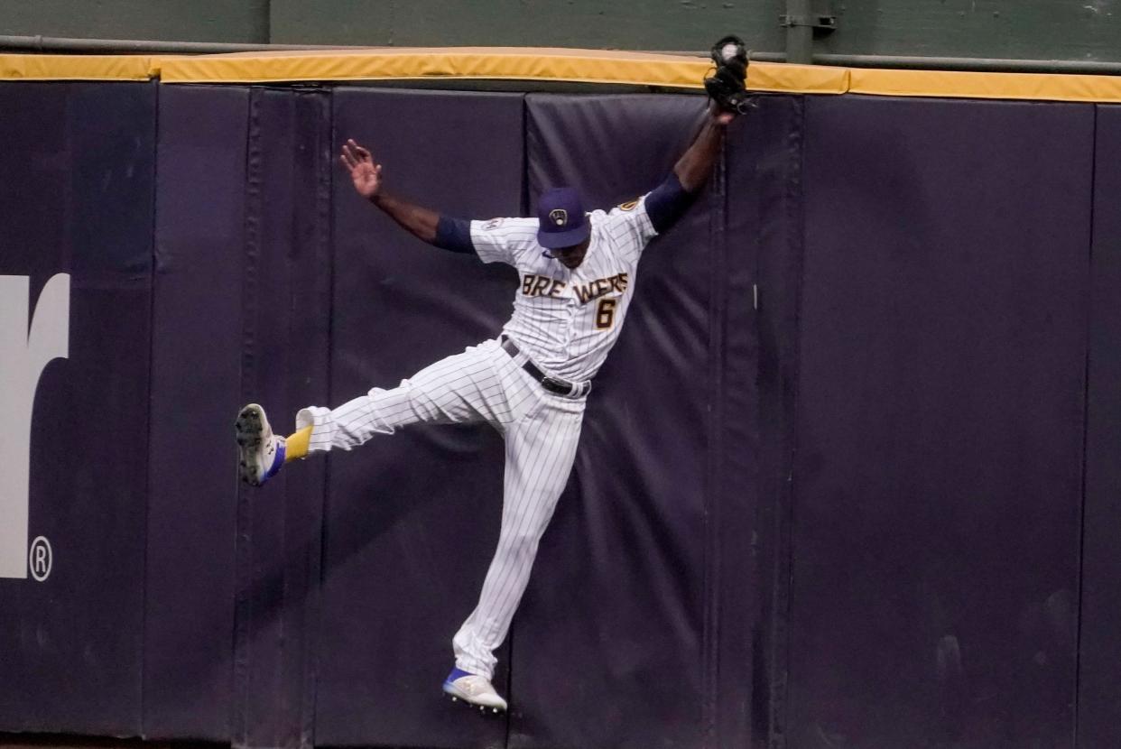 Milwaukee Brewers' Lorenzo Cain hits the wall as he catches a long fly ball hit by Chicago Cubs' Willson Contreras during the second inning of a baseball game Saturday, Sept. 18, 2021, in Milwaukee. (AP Photo/Morry Gash) ORG XMIT: WIMG109