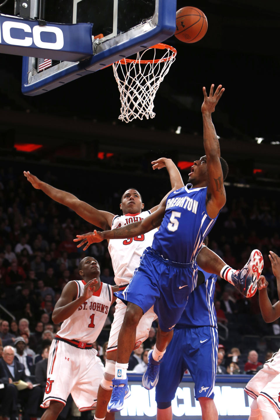 Creighton's Devin Brooks (5) shoots against St. John's Orlando Sanchez, of the Dominican Republic, during the first half of an NCAA college basketball game, Sunday, Feb. 9, 2014, in New York. (AP Photo/Jason DeCrow)