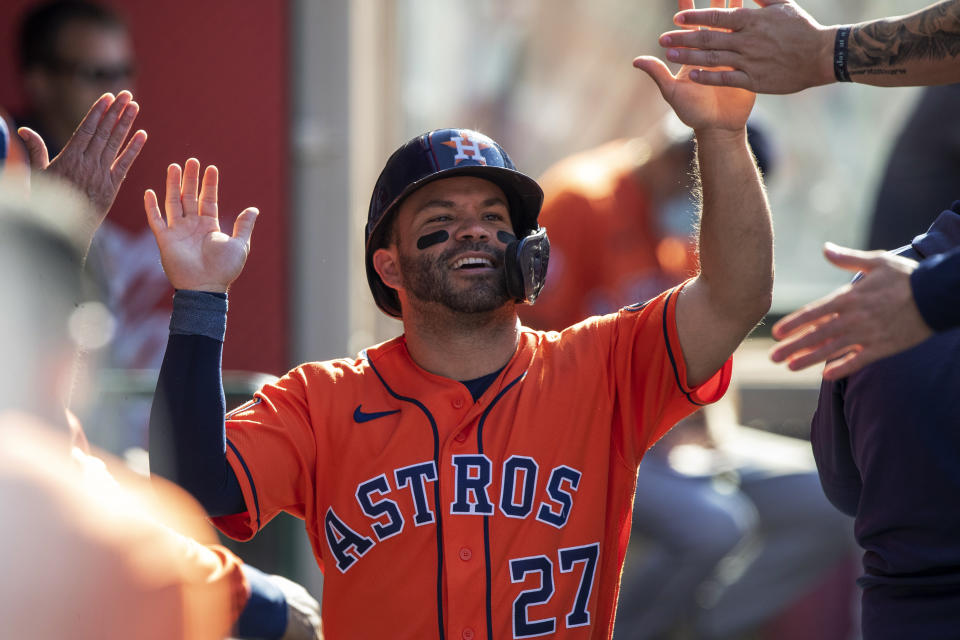 Houston Astros' Jose Altuve gets congratulations in the dugout after scoring on a single by Kyle Tucker against the Los Angeles Angels during the first inning of a baseball game in Anaheim, Calif., Thursday, July 14, 2022. (AP Photo/Alex Gallardo)