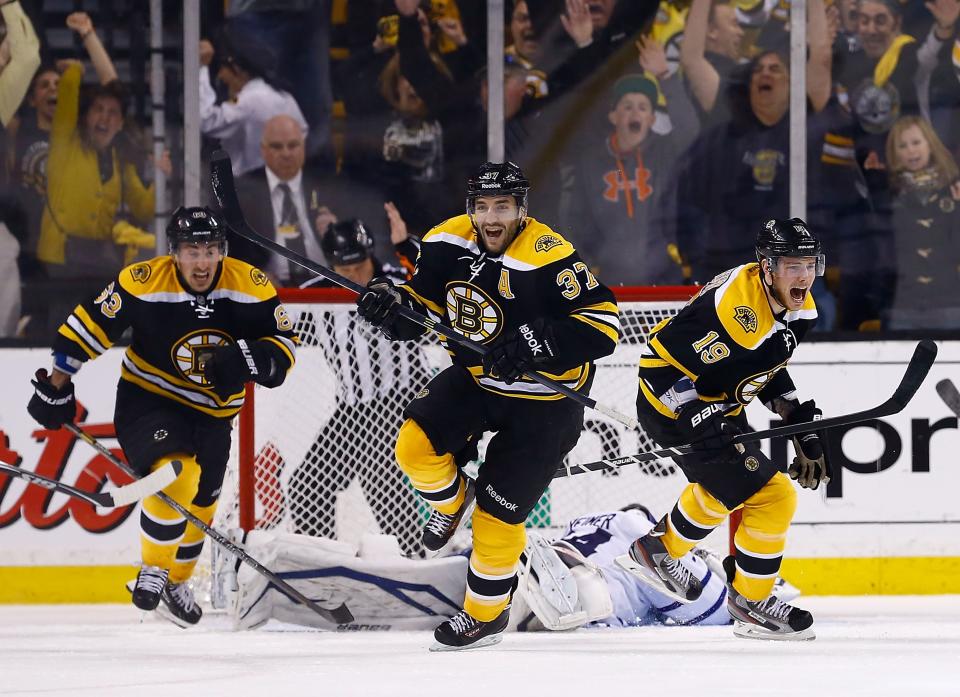 BOSTON, MA - MAY 13: Patrice Bergeron #37, Tyler Seguin #19, and Brad Marchand #63 of the Boston Bruins celebrate following Bergeron's game-winning overtime goal against the Toronto Maple Leafs in Game Seven of the Eastern Conference Quarterfinals during the 2013 NHL Stanley Cup Playoffs on May 13, 2013 at TD Garden in Boston, Massachusetts. (Photo by Jared Wickerham/Getty Images)