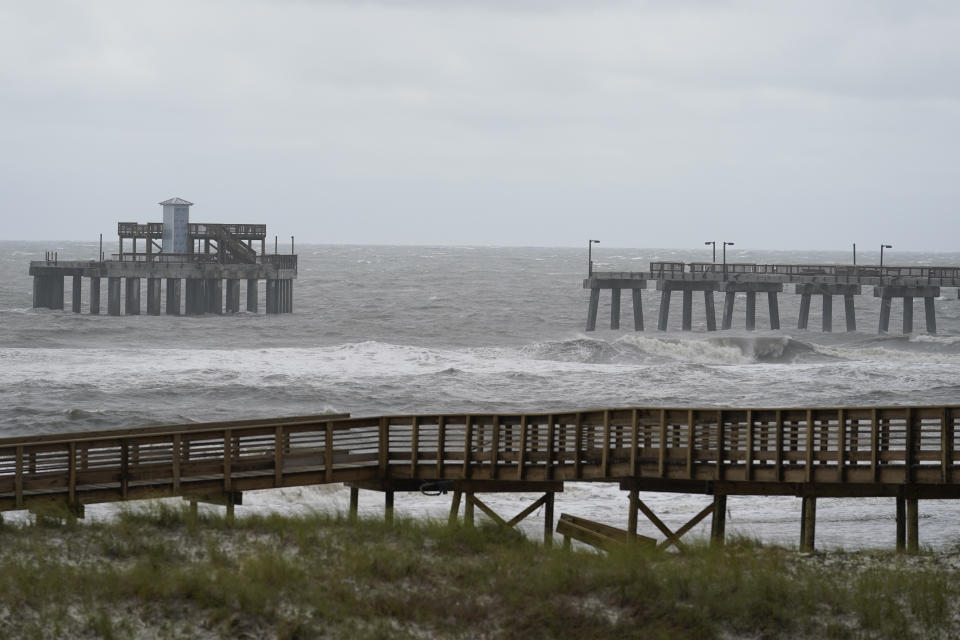 Waves move near a damaged pier at Gulf State Park after Hurricane Sally moved through, Wednesday, Sept. 16, 2020, in Gulf Shores, Ala. The hurricane made landfall Wednesday near Gulf Shores, Alabama, as a Category 2 storm, pushing a surge of ocean water onto the coast and dumping torrential rain that forecasters said would cause dangerous flooding from the Florida Panhandle to Mississippi and well inland in the days ahead.(AP Photo/Gerald Herbert)