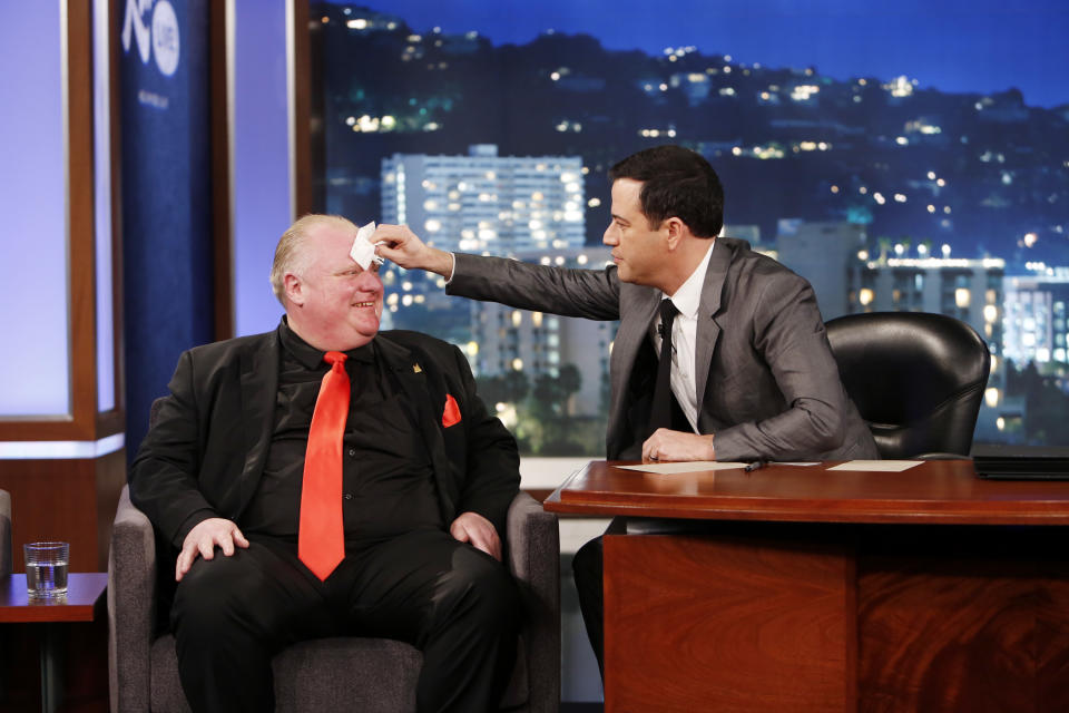 This March 3, 2014 image released by ABC shows Toronto Mayor Rob Ford, left, having his forehead wiped by host Jimmy Kimmel on the late night talk show "Jimmy Kimmel Live," in Los Angeles. Ford laughed off Jimmy Kimmel's suggestion that he get help for his drinking problem and was reported to be upset about his appearance on the late-night TV talk show. Ford's appearance Monday night on "Jimmy Kimmel Live" in Los Angeles was the culmination of months of wooing by the talk-show host to get Ford to appear as a guest. (AP Photo/ABC, Randy Holmes)