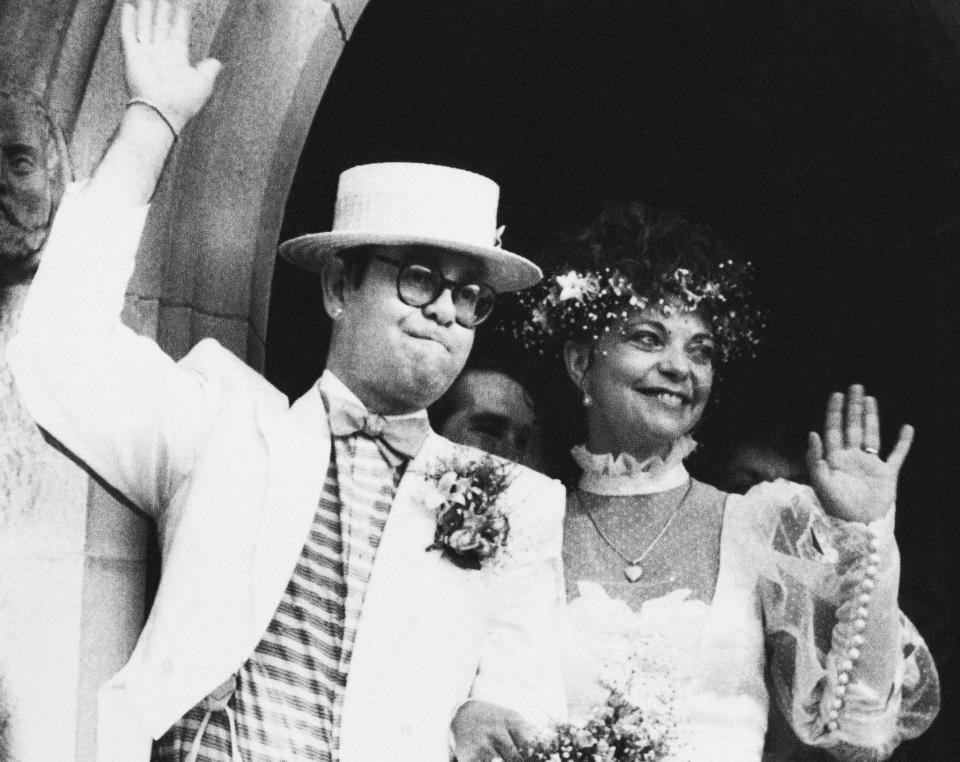 British rock star Elton John with his bride, Renate Blauel, wave upon leaving St. Mark's church in Sydney, Australia, Feb 14,1984. (AP Photo)