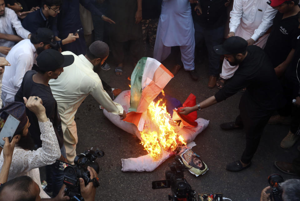 Supporters of a Pakistani religious group burn an effigy depicting former Bharatiya Janata Party spokeswoman Nupur Sharma during a demonstration to condemn derogatory references to Islam and the Prophet Muhammad recently made by Sharma, a spokesperson of the governing Indian Hindu nationalist party, Friday, June 10, 2022, in Karachi, Pakistan. (AP Photo/Fareed Khan)