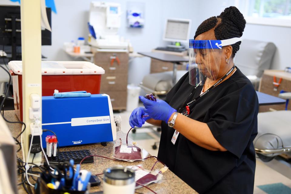 Fulvia Gallimore, a phlebotomist at the OneBlood donor center in Vero Beach, prepares two bags of packed red blood cells for shipment Thursday, March 19, 2020, as the need for blood donations rises due to the coronavirus outbreak. "We can maximize a donor's potential by seating their blood type," said Larry Thompson, team leader at the center. "For example, certain blood types yield better red blood cells or plasma. We're always looking for someone to donate platelets because they only have a shelf-life of five days."