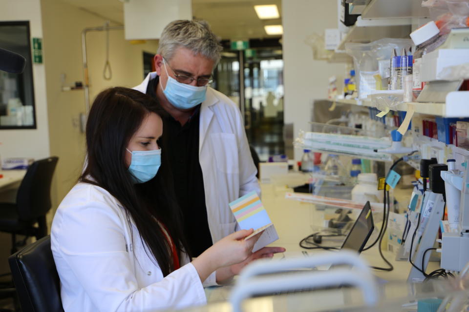 Pictured is researcher Leah Beauchamp and Professor Kevin Barnham from the Florey Institute in a laboratory. 