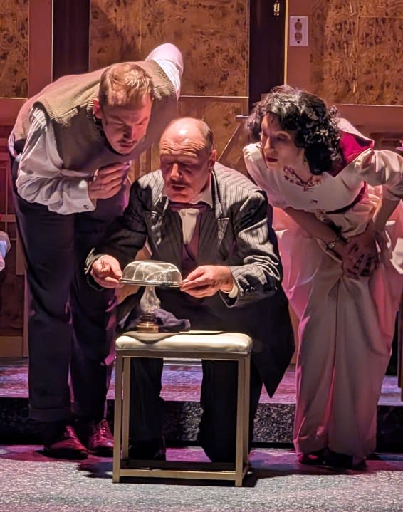 Kyle DeFauw as Monsieur Bouc, Tom Walljasper as Hercule Poirot, and Cara Moretto as Countess Elena examine a clue in “Murder on the Orient Express.”