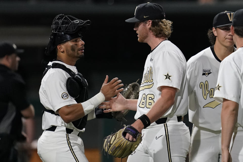 Vanderbilt catcher Alan Espinal, left, congratulates pitcher Thomas Schultz (66) after the team's 12-2 win against Eastern Illinois in an NCAA college baseball tournament regional game Friday, June 2, 2023, in Nashville, Tenn. (AP Photo/George Walker IV)