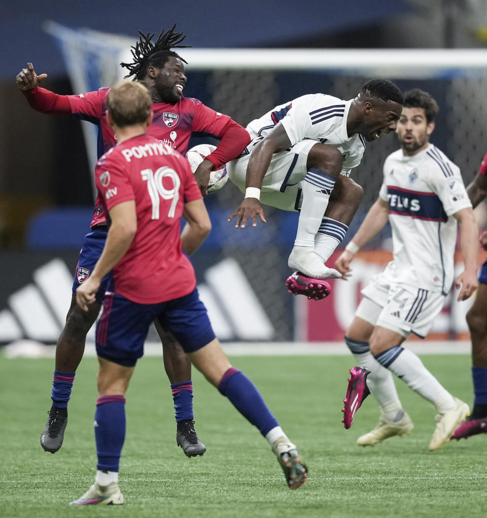 Vancouver Whitecaps' Cristian Dajome loses his shoe as he vies for the ball against FC Dallas' Ema Twumasi, back left, during the first half of an MLS soccer match in Vancouver, British Columbia, Saturday, March 11, 2023. (Darryl Dyck/The Canadian Press via AP)