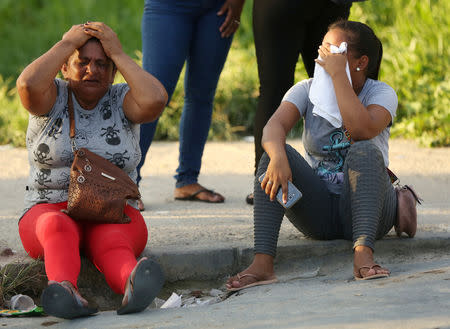 Relatives of inmates react in front of a prison complex in the Brazilian state of Amazonas after prisoners were found strangled to death in four separate jails, according to the penitentiary department in Manaus, Brazil May 27, 2019. REUTERS/Bruno Kelly