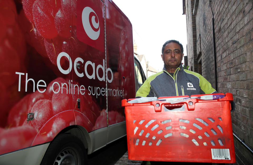 A delivery driver for Ocado online supermarket delivers a shopping order in Ironbridge, Shropshire the day after Prime Minister Boris Johnson put the UK in lockdown to help curb the spread of the coronavirus. (Photo by Nick Potts/PA Images via Getty Images)