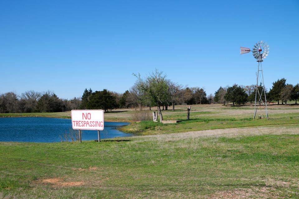 A pond, windmill and driveway are all that remain of Samantha Brewer's former home in Harrah.