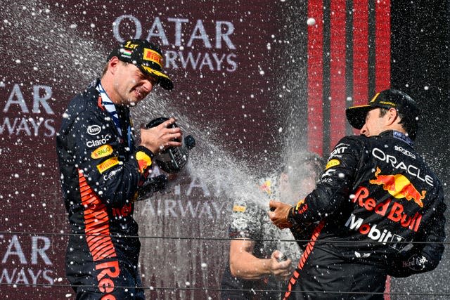 Max Verstappen, left, sprays champagne on the podium with third-placed team-mate Sergio Perez in Hungary