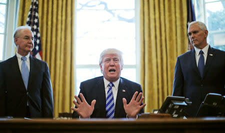 FILE PHOTO: President Trump reacts to the AHCA health care bill being pulled by Congressional Republicans before a vote as he appears with Secretary of Health and Human Services Tom Price (L) and Vice President Mike Pence (R) in the Oval Office of the White House in Washington, U.S., March 24, 2017. REUTERS/Carlos Barria/File Photo