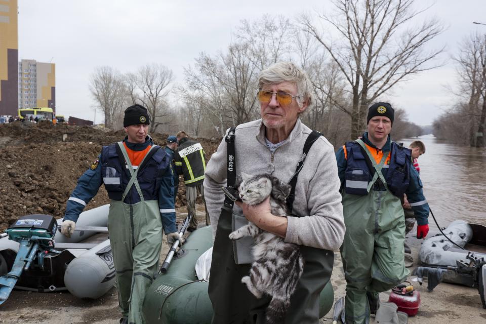 A man holds his cat as he pulls a boat with emergency workers in a flooded area in Orenburg, Russia, Wednesday, April 10, 2024. Russian officials are scrambling to help homeowners displaced by floods, as water levels have risen in the Ural River. The floods in the Orenburg region near Russia's border with Kazakhstan sparked the evacuation of thousands of people following the collapse of a dam on Saturday. (AP Photo)