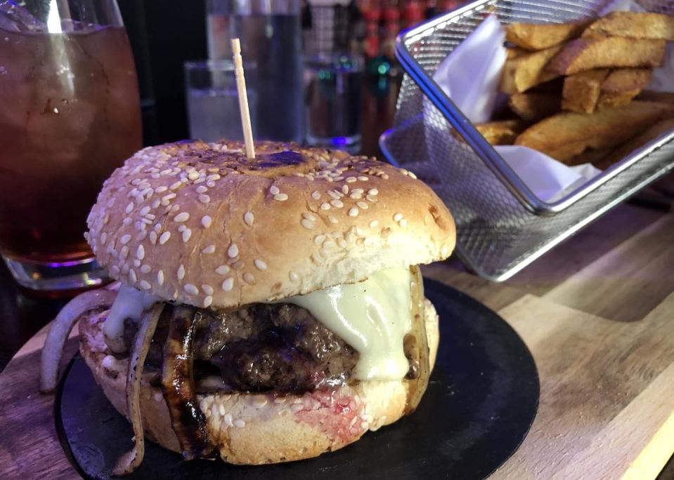A burger topped with Worcestershire sauteed onions, mushrooms and cheese at The Rock Yard in Old Towne Petersburg.