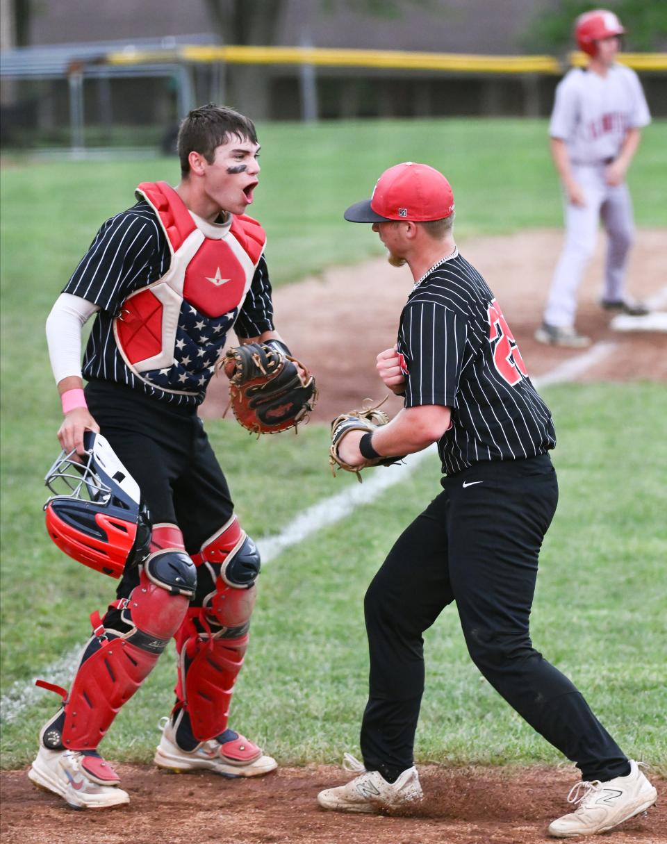 Eastern Greene catcher Jack Rees (left) and Gavin Whitfield celebrate after turning a double play during the baseball game against Bloomfield at Eastern Greene on Friday, May 3, 2024.